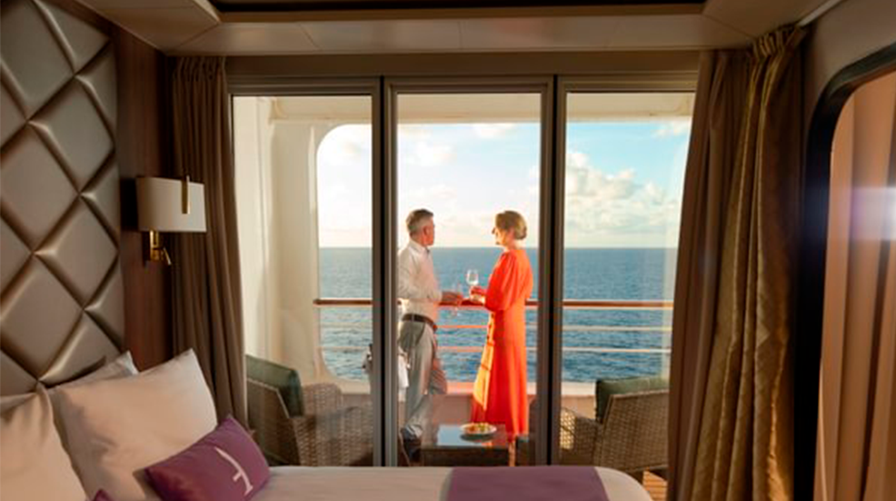 Couple on balcony of Ambassador cruise